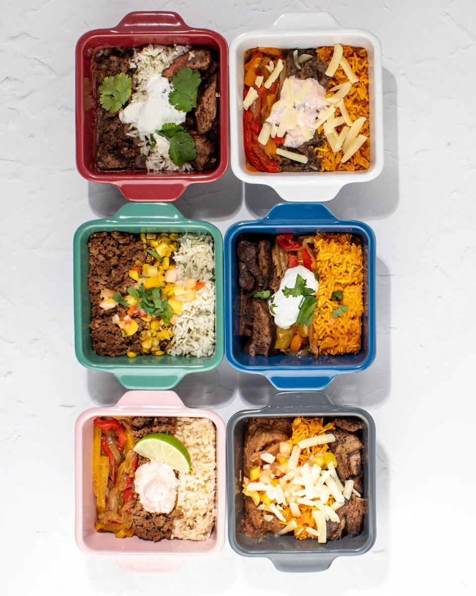 Six finished meals in colored baking dishes